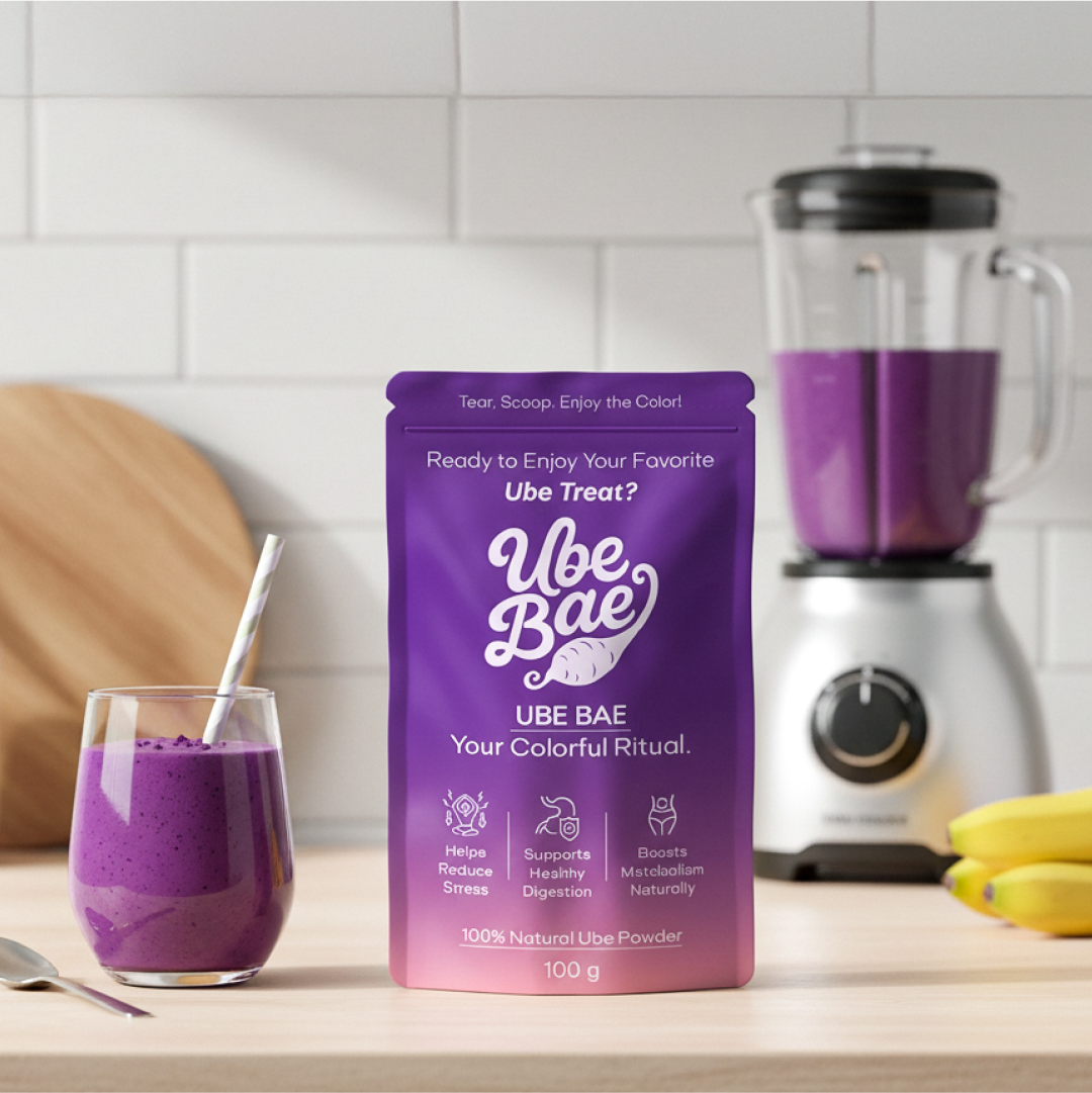 Purple Ube Bae packaging with a glass of purple smoothie and blender in the background.
