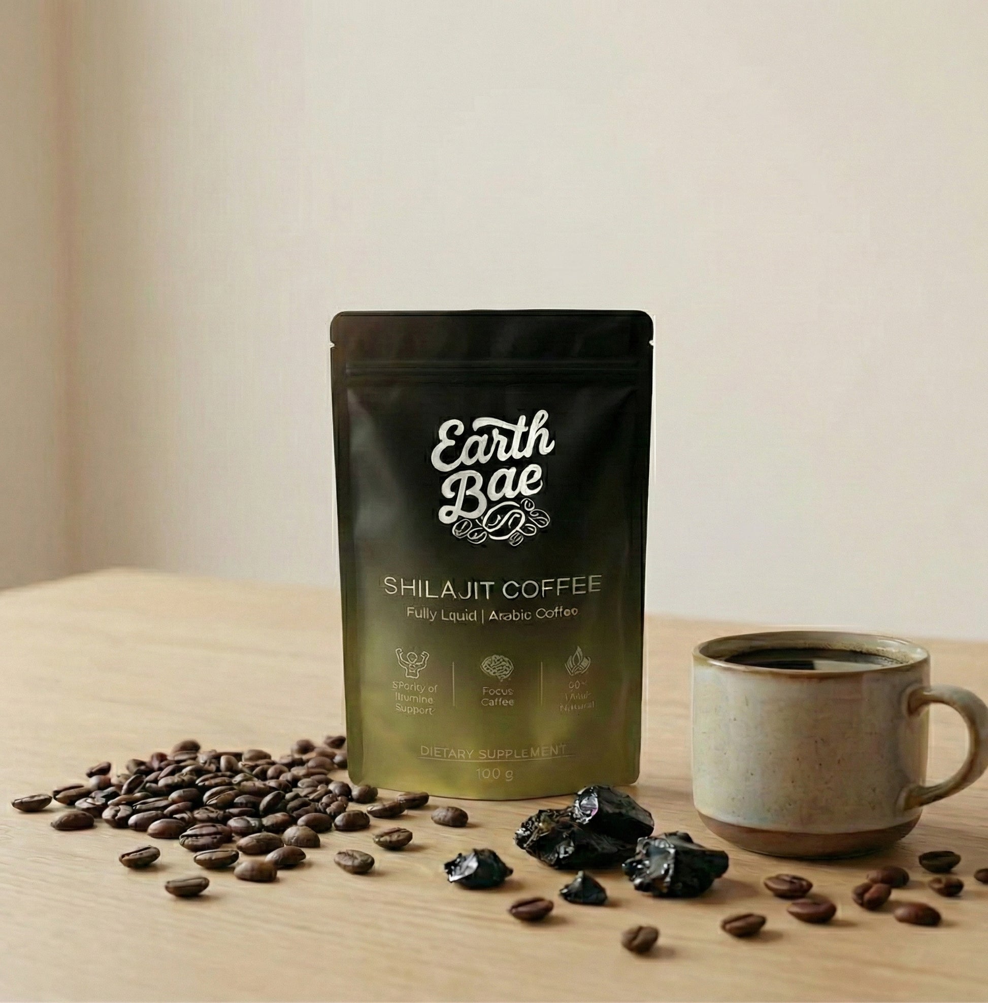 Earth Bae organic Shilajit Coffee package with coffee beans and a mug on a wooden surface