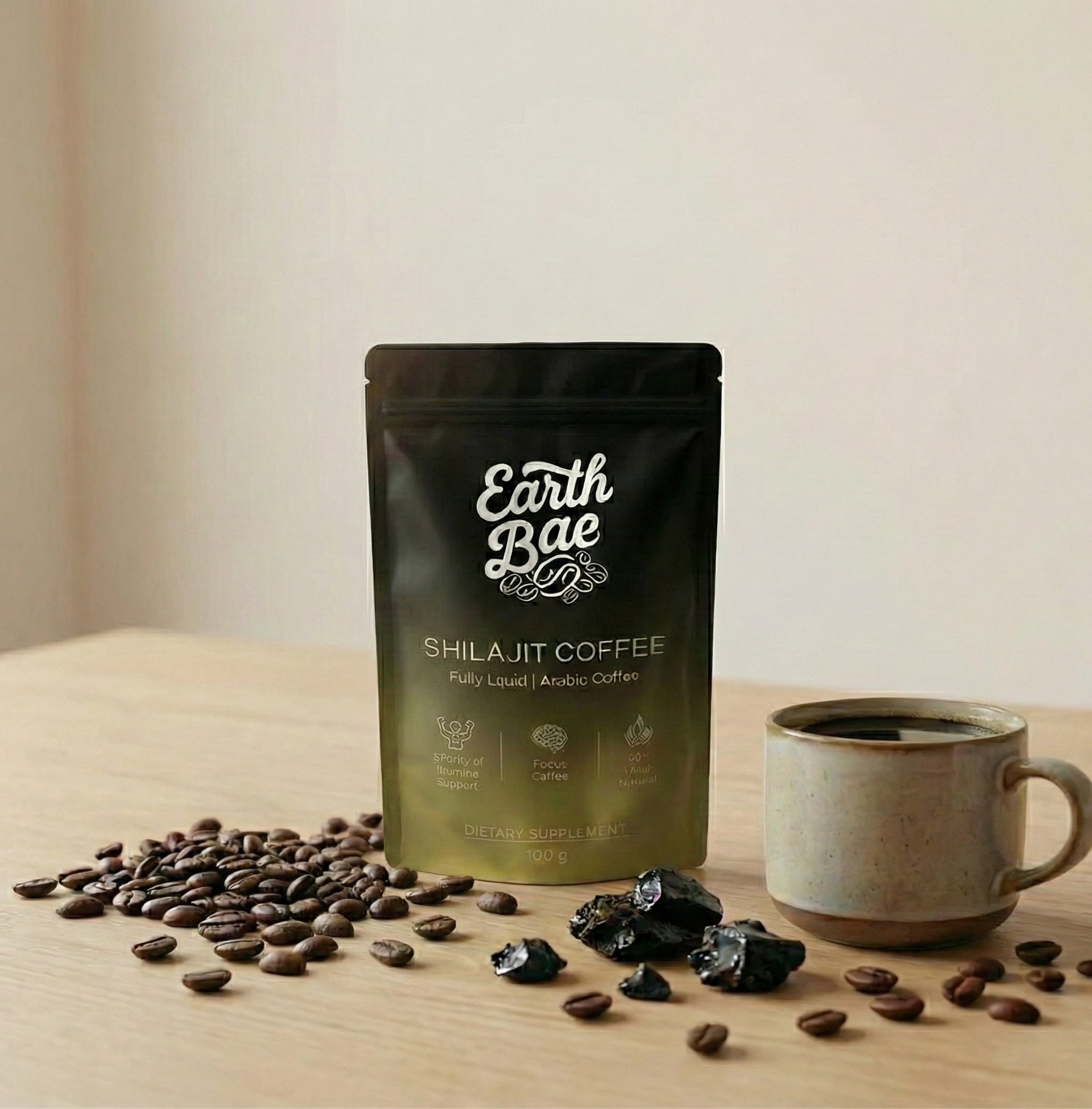 Earth Bae organic Shilajit Coffee package with coffee beans and a mug on a wooden surface