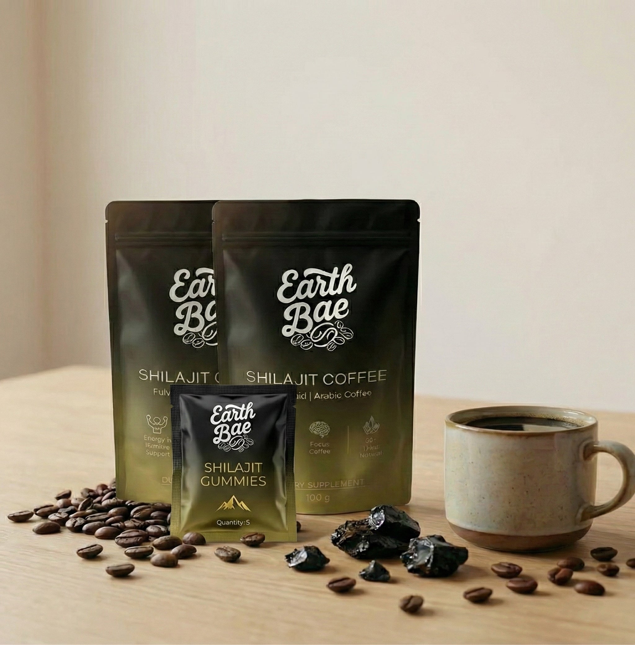 Earth Bae organic shilajit coffee and gummies with coffee beans and a mug on a wooden surface.